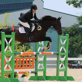 Jeri on horse Oliver jumping obstacle